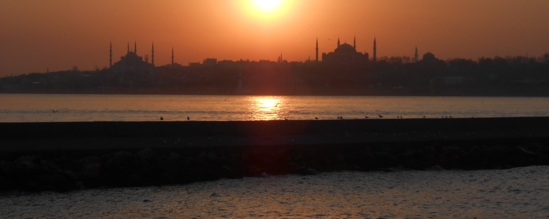 Mosques and minarets silhouetted by Istanbul sunset