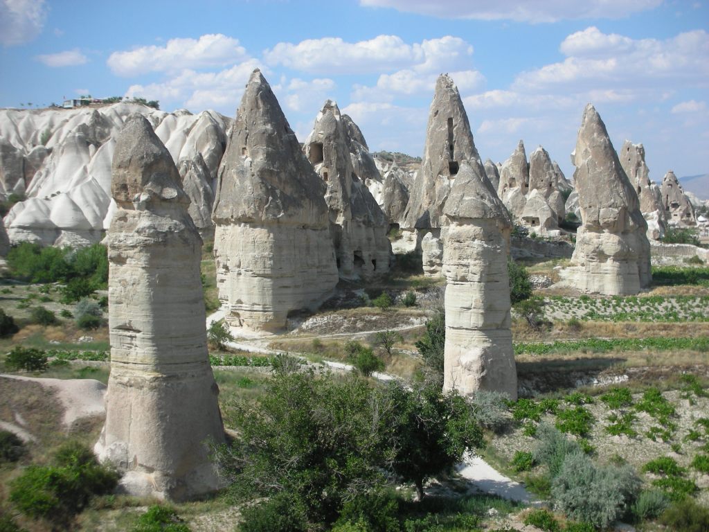 Mushroom-like white and gray rock formations in the Love Valley, Cappadochia