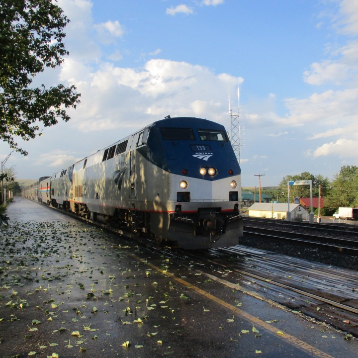 Train arriving Glacier Park station after brief hailstorm