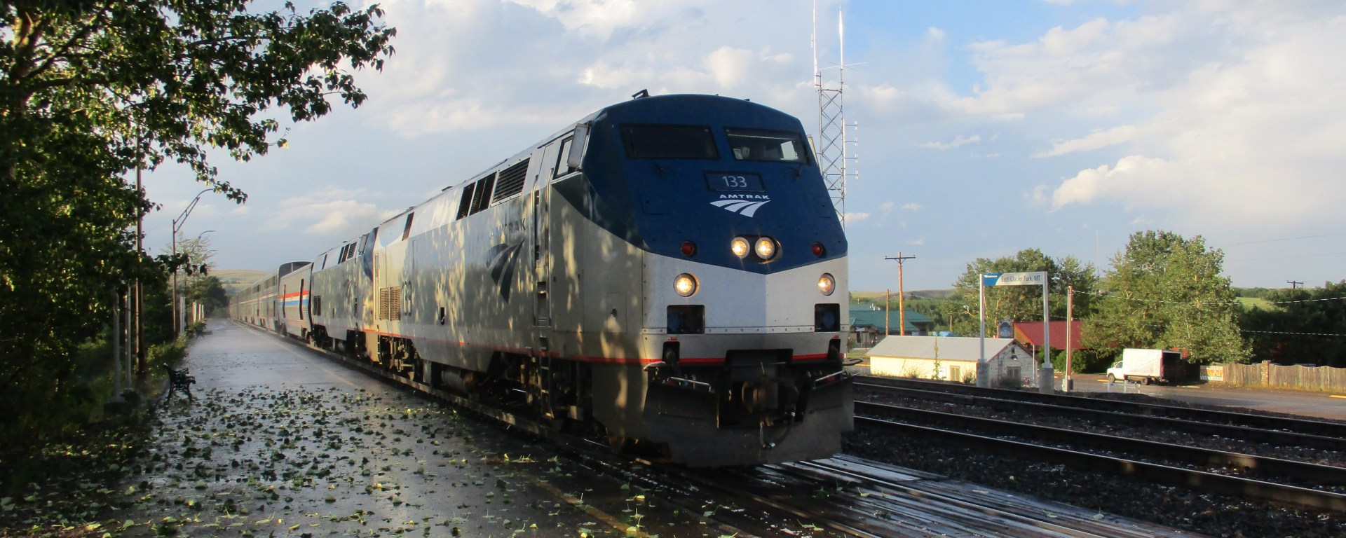 Train arriving Glacier Park station after brief hailstorm