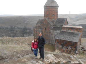 Couple standing in front of ancient Ani church on the Turkish-Armenian border