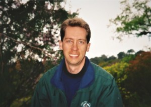 man smiling in green garden near Cape Town city