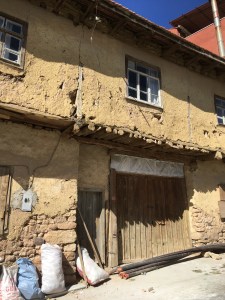 a traditional village home covered in yellow clay siding in central Turkey