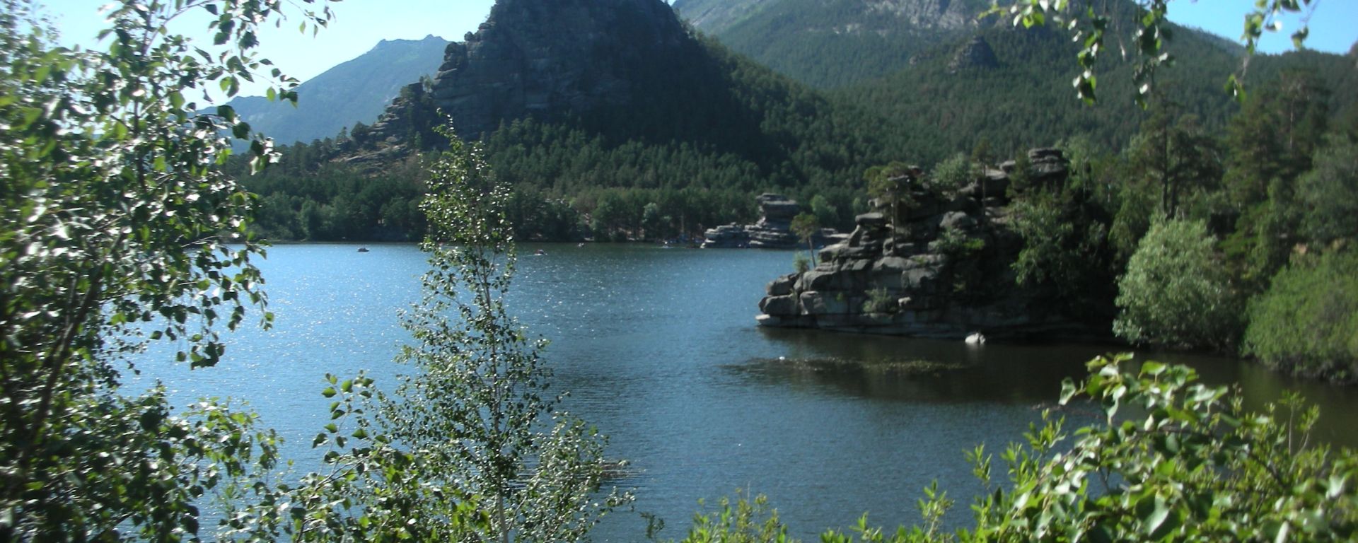 mountain lake with forest surrounding it